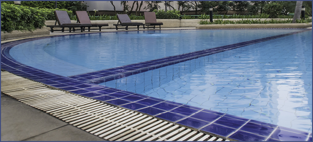 edge of two swimming pool with sunny reflection